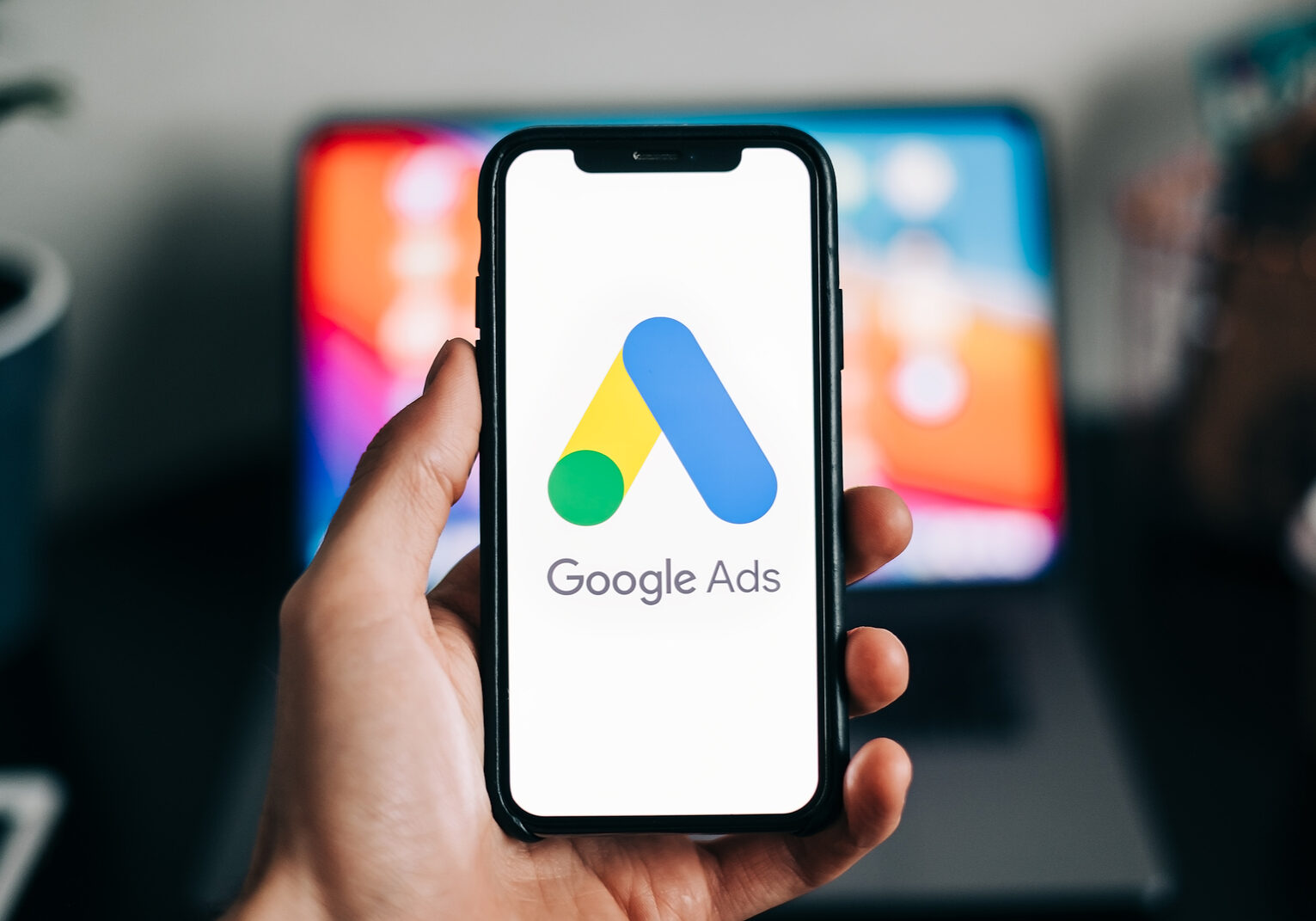 Google Ads logo on smartphone screen in hand. Rostov-on-Don, Russia. 15 February 2021